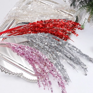 Sparkly Christmas sequin branches in red and silver on a decorative metal tray