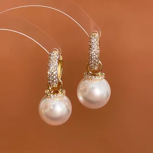Elegant gold plated hoop earrings with zircon studded circles and white round pearls