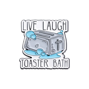 Creative enamel toaster pin with blue foam accents and dark humor text on white backdrop