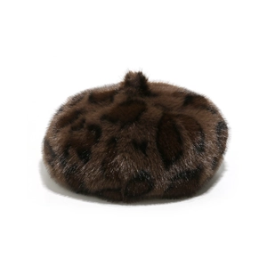 Detailed view of leopard print faux fur beret hat with soft plush texture on white background