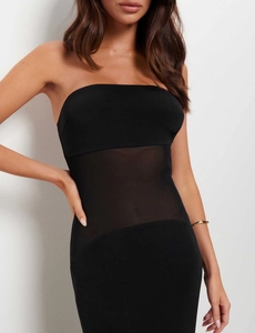 Detailed close-up of a sexy black tube dress with sheer mesh patchwork on the waistline