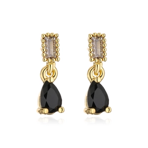 Detail of 18K gold teardrop earrings with champagne rectangle and black pear crystals