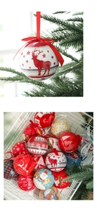 Close-up of festive tin Christmas ball ornaments with reindeer and snowflake patterns