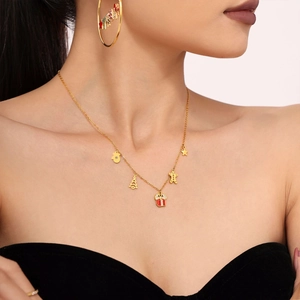 Gold Christmas necklace with enamel pendants and Merry letter earrings on model