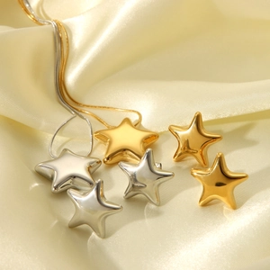 Detailed view of minimalist 18K gold and silver stainless steel star jewelry set