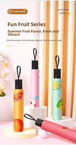 Detail of compact fruit pattern sun umbrellas with black UV protection coating