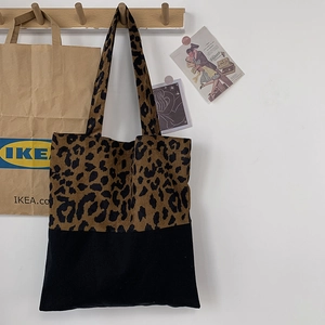 Detail of leopard print canvas tote bag featuring premium texture and large capacity
