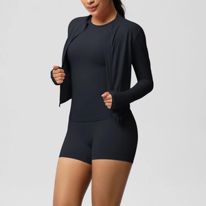 Three-piece black yoga set with zipper hoodie, sports bra, and matching fitness shorts