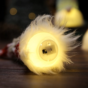 Illuminated faceless gnome Christmas tree ornament with warm LED light and battery base