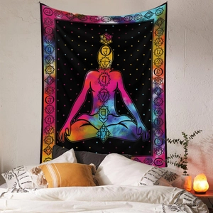 Detail of meditation yoga tapestry with seven chakra symbols hanging on bedroom wall