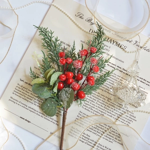 Artificial red berry pine branch with snow finish on vintage letter background