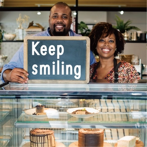 Staff holding a wooden board by bakery display with 1.5 inch waterproof black vinyl letters