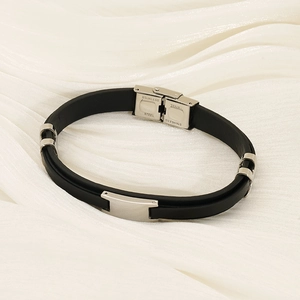 Modern double-layer stainless steel and black silicone bracelet on white silk fabric