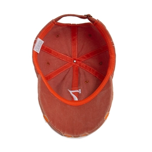 Washed cotton baseball cap in brick red with embroidery and distressed brim detail