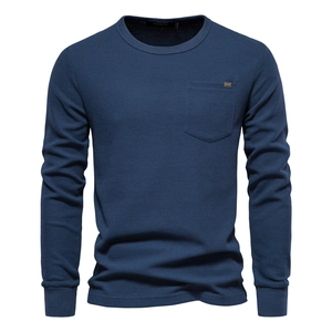 Detailed view of dark blue waffle knit texture and chest pocket on long sleeve t-shirt