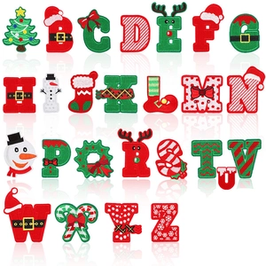 Detailed close-up of 26 Christmas alphabet patches with festive tree and snowman embroidery