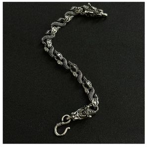 Detailed view of silver hip hop dragon bone bracelet on a dark background