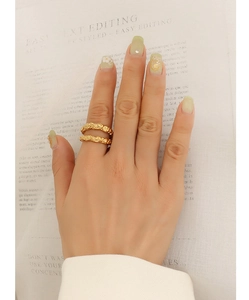 Detail of 18k gold plated titanium steel rings with hammered foil texture on hand