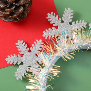 Detail of silver glitter snowflakes and colorful tinsel on Christmas headband