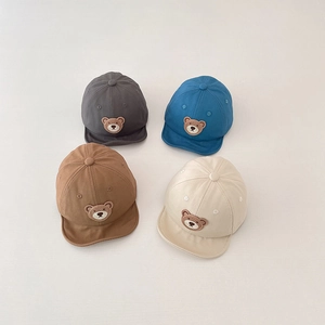 Detail view of four baby soft brim baseball caps with 3D bear embroidery in multiple colors