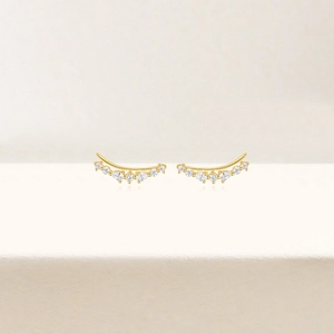 Macro detail of gold S925 silver ear crawlers with marquise and round cubic zirconia