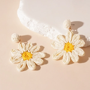 Handmade woven daisy flower earrings with white petals and yellow centers for women