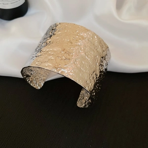 Detail showing the hammered texture and silver finish of this wide cuff bracelet