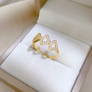 Close-up of golden ginkgo leaf ring with sparkling crystals in a jewelry box