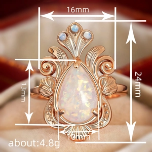 Vintage rose gold teardrop opal ring with blue stones and intricate hollow leaf design