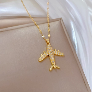 Elegant gold titanium necklace featuring a luxury airplane pendant with shimmering cubic zirconia