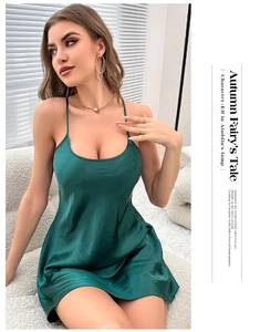 Close-up of dark green silk satin nightdress with thin straps and glossy texture