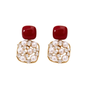 Vintage 18k gold plated earrings with red square stones and pearls on white background