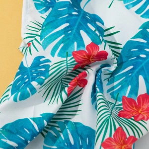 Hawaiian style pet shirt with tropical palm leaves and hibiscus floral print