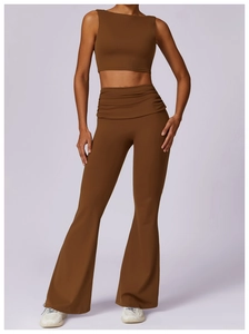 Detail of high-waisted brown yoga flare pants with unique ruched waistband design