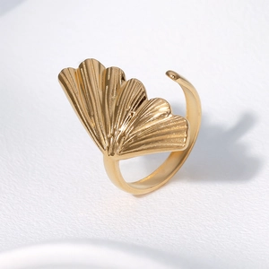 Adjustable 18K gold plated stainless steel ginkgo leaf ring on a white textured surface