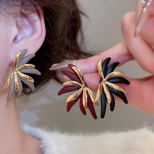 Close-up of 18k gold plated floral earrings in grey, burgundy and black colors
