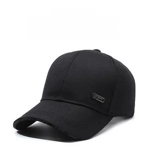 Detail of black baseball cap with sports printing on brim and side metal badge