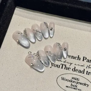 Handmade grey cat-eye almond press-on nails with luxury rhinestones and bead accents