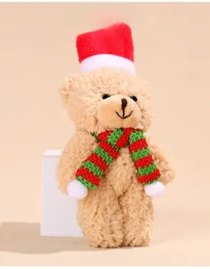 Detail of plush Christmas teddy bear with knit hat and striped scarf for cake decoration