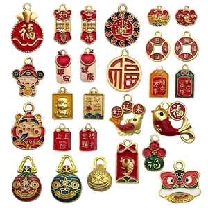 Traditional Chinese New Year gold charms with red enamel lucky symbols on white background