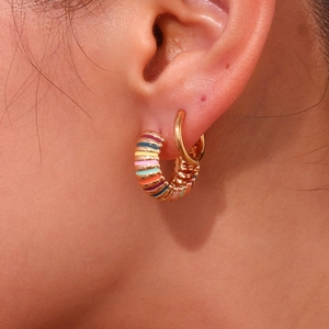 Fashionable 18K gold plated stainless steel hoops with colorful enamel stripes on a model
