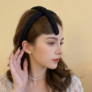 Elegant wide black bow headband with embroidered detail for a high crown hairstyle look