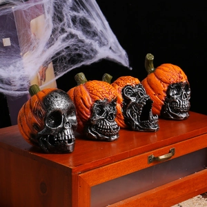 Set of 4 resin Halloween skull pumpkin figurines displayed on a vintage cabinet