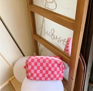 Macro detail of pink and white checkered knitted cosmetic bag with soft woven texture