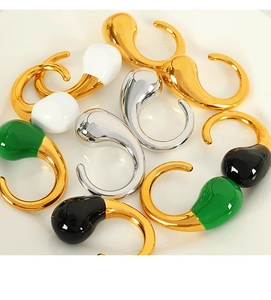 Close-up of assorted enamel drip glaze stud earrings in gold, silver, black, and green