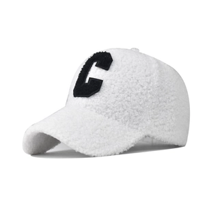 Detail of soft white lamb wool texture and black letter C embroidery on baseball cap