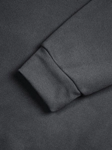 Detail shot of the ribbed cuffs on a dark grey vintage style half-zip sweatshirt