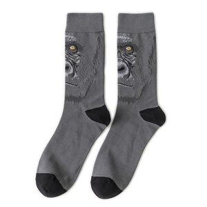 Macro view of knit crew socks featuring realistic gorilla face with yellow eyes