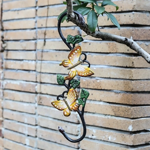 Retro cast iron S-shaped butterfly hook with orange hand-painted wings for garden decor
