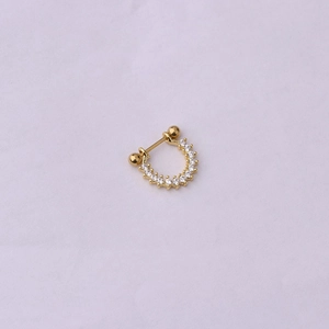 Detail view of golden U-shaped stud earring with paved white zircons and ball screw back